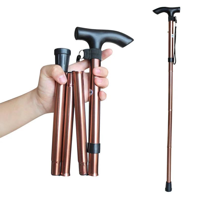Collapsible walking cane with rose gold finish and black handle held by a hand on a white background